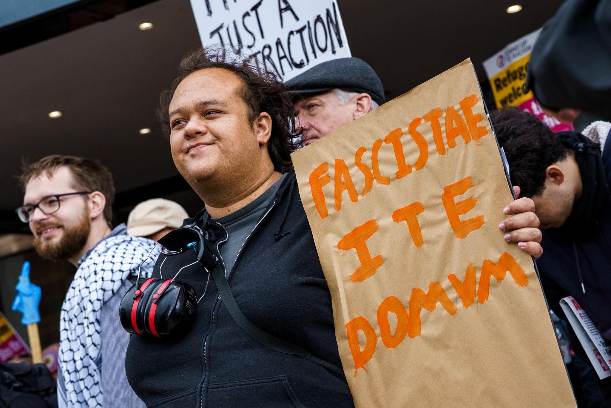 Protester Holds a Placard saying "Facistae ite domum"